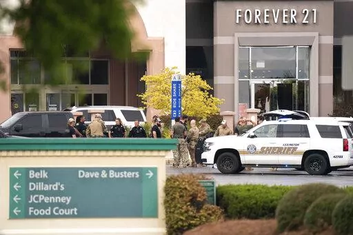 Members of law enforcement gather outside Columbiana Centre mall in Columbia, S.C., following a shooting, April 16, 2022. Authorities in South Carolina say they are investigating shooting at a club in Hampton County early Sunday, April 17, 2022 that left at least nine people injured. It was the second mass shooting in the state in as many days. (AP Photo/Sean Rayford)