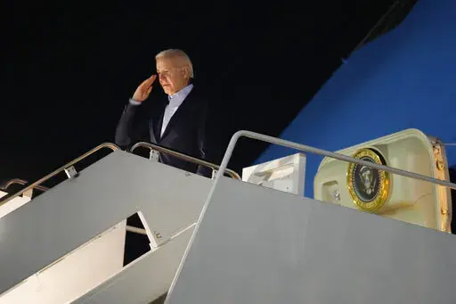 President Joe Biden salutes as he boards Air Force One at Andrews Air Force Base, Md., on Tuesday, Dec. 27, 2022. Biden and his family are traveling to St. Croix, U.S. Virgin Islands, to celebrate New Year. (AP Photo/Manuel Balce Ceneta)