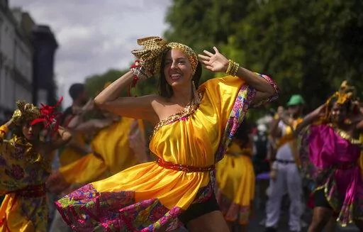 Performers attend the Family Day at the Notting Hill Carnival in London, Sunday Aug. 28, 2022. The Carnival returned to the streets for the first time in two years, after it was thwarted by the pandemic. (Victoria Jones/PA via AP)