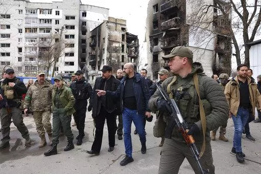 In this image provided by the European Council, European Council President Charles Michel, center, as he is given a tour of the region of Borodyanka, Ukraine, Wednesday, April 20, 2022. (Dario Pignatelli/European Council via AP)