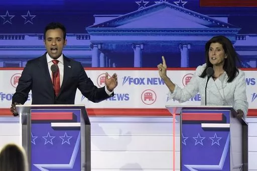 Businessman Vivek Ramaswamy, left, and former U.N. Ambassador Nikki Haley speak during a Republican presidential primary debate hosted by FOX News Channel, Aug. 23, 2023, in Milwaukee. Ramaswamy and Haley, two of the leading contenders for the Republican presidential nomination, are Indian Americans, even though polling points to an Indian diaspora that overwhelmingly votes Democrat. The two candidates are running significantly behind former President Donald Trump and also trail Florida Gov. Ron