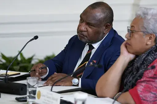 Papua New Guinean Prime Minister James Marape, left, listens during a meeting with Pacific Islands Forum leaders during the U.S.-Pacific Islands Forum Summit in the East Room of the White House, Monday, Sept. 25, 2023, in Washington. Prime Minister Marape accused Joe Biden of disparaging the South Pacific island nation by implying that an uncle of the U.S. president had been eaten by “cannibals” there during World War II. (AP Photo/Evan Vucci, File)