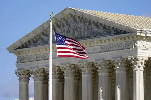 An American flag waves in front of the Supreme Court building on Capitol Hill in Washington, on Nov. 2, 2020. The Supreme Court on Monday agreed to review a challenge to the consideration of race in college admission decisions, often known as affirmative action. The justices are taking up a pair of lawsuits alleging that Harvard University and the University of North Carolina discriminate against Asian American applicants. (AP Photo/Patrick Semansky, File)