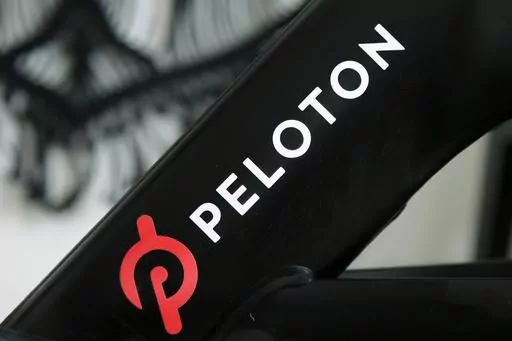 A Peloton logo is seen on the company's stationary bicycle on Nov. 19, 2019, in San Francisco, Calif. Peloton is recalling more than 2 million of its exercise bikes because the bike’s seat post assembly can break during use, posing fall and injury hazards. (AP Photo/Jeff Chiu, File)