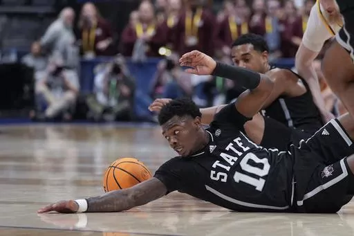 Mississippi State guard Dashawn Davis (10) reaches for a loose ball during the second half of an NCAA college basketball game against LSU at the Southeastern Conference tournament Thursday, March 14, 2024, in Nashville, Tenn. (AP Photo/John Bazemore)