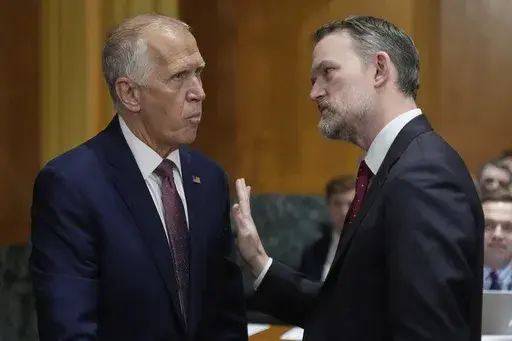 Sen. Thom Tillis, R-N.C., left, talks with U.S. Trade Representative Jamieson Greer ahead of a hearing at the Senate Finance Committee on Capitol Hill in Washington, Tuesday, April 8, 2025. (AP Photo/Mark Schiefelbein)