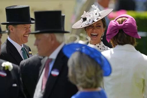 Kate, Duchess of Cambridge, second right, laughs as she stands in the paddock on the fourth day of the Royal Ascot horserace meeting, at Ascot Racecourse, in Ascot, England, Friday, June 17, 2022. Every June, Britain's royals, aristocrats and thousands of stylish guests don their finest headgear for Royal Ascot, a glamorous annual horse racing event that dates back to 1711, when Queen Anne founded Ascot Racecourse in Berkshire, southern England. (AP Photo/Alastair Grant)