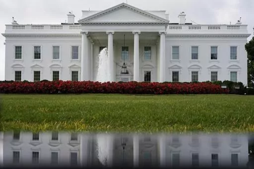 The White House is seen reflected in a puddle, Sept. 3, 2022, in Washington. The U.S. Senate confirmed Todd Gee on Friday, Sept. 29, 2023, to be the U.S. Attorney for the Southern District of Mississippi, putting him in charge of prosecuting the largest public corruption scandal in state history. (AP Photo/Carolyn Kaster, File)