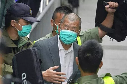 Democracy advocate Jimmy Lai, center, leaves the Hong Kong's Court of Final Appeal in Hong Kong on Feb. 9, 2021. Lai was sentenced to five years and nine months in prison over two fraud charges linked to lease violations in Hong Kong on Saturday, Dec. 10, 2022 the latest of a series of cases against prominent activists that critics say are aimed at snuffing out dissidents in the city. (AP Photo/Kin Cheung, File)