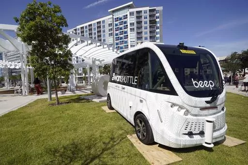 The new self driving SWAN (Shuttling with Autonomous Navigation) shuttle bus is displayed Wednesday, Aug. 16, 2023, in Orlando, Fla. The SWAN shuttle seats up to eight passengers and will run along a one-mile route in downtown Orlando. (AP Photo/John Raoux)