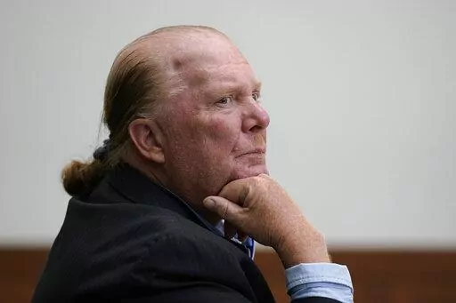 Celebrity chef Mario Batali listens at Boston Municipal Court on the first day of his pandemic-delayed trial, Monday, May 9, 2022, in Boston. Batali pleaded not guilty to a charge of indecent assault and battery in 2019, stemming from accusations that he forcibly kissed and groped a woman after taking a selfie with her at a Boston restaurant in 2017. (AP Photo/Steven Senne, Pool)