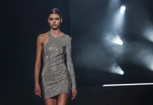 Fashion from Michael Kors' fall/winter 2022 collection is modeled during Fashion Week, Tuesday, Feb. 15, 2022, in New York. (AP Photo/Bebeto Matthews)