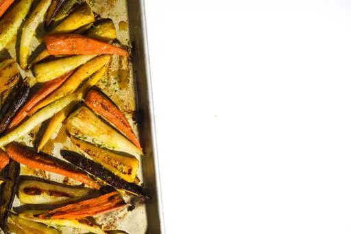 This image released by Milk Street shows a recipe for roasted carrots with the turmeric-infused honey. (Milk Street via AP)