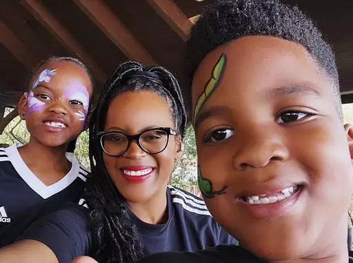 This image provided by Lakesha Cole shows Kirby, Lakesha and Keegan Cole during winter school break on December 30, 2022, at Legoland in Winter Haven, Fla. Family fun and a flexible schedule are priorities during school breaks, but Cole begins putting systems in place to organize her home and get her kids on an early bedtime schedule ahead of the first day of school. (Lakesha Cole via AP)