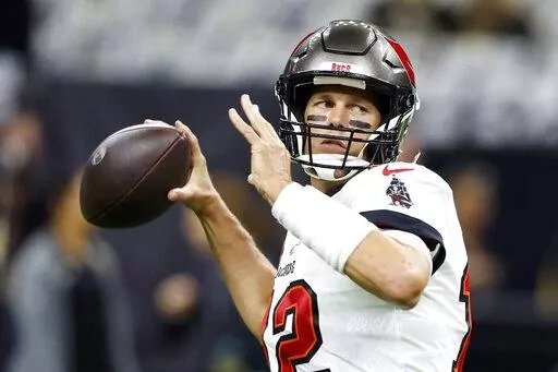 Tampa Bay Buccaneers quarterback Tom Brady warms up before the first half of an NFL football game against New Orleans Saints in New Orleans, Sunday, Sept. 18, 2022. In some Tampa Bay area schools, students use foam rollers and vibrating spheres to massage their muscles as they work toward goals for strength and flexibility. It's all part of a new physical education curriculum from Brady, whose vision for healthy living is fueling a fitness empire. (AP Photo/Butch Dill, File)