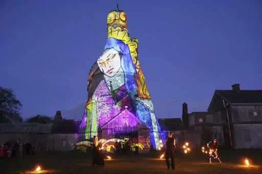 Dancers perform in front of an image of St. Brigid projected onto The Wonderful Barn in Leixlip, Kildare, Ireland, Tuesday, Jan. 31, 2023 during the Herstory Festival of Light. Devotees of St. Brigid in Ireland plan to celebrate on Sunday, Jan. 28, 2024, with the scheduled return of a relic associated with the so-called “matron saint of Ireland” — about a millennium after her remains were removed from her hometown of Kildare. It's part of a series of observances in Ireland and around the w
