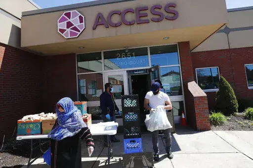 Workers at ACCESS, the Arab Community Center for Economic and Social Services, help with meals for the Arab community in Dearborn, Mich., on May 1, 2020.  The federal government is taking preliminary steps toward revising racial and ethnic classifications on census and survey forms for the first time in a quarter century following calls to create a new category for people of Middle Eastern and North African descent and a desire to make categories less confusing for Hispanic participants. (AP Pho