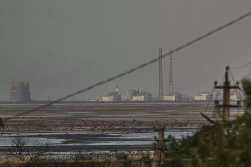 The Zaporizhzhia nuclear power plant, Europe's largest, is seen in the background of the shallow Kakhovka Reservoir after the dam collapse, in Energodar, Russian-occupied Ukraine, Tuesday, June 27, 2023. Officials at the Russian-controlled Zaporizhzhia Nuclear Power Plant said that the site was attacked Sunday April 7, 2024, by Ukrainian military drones, including a strike on the dome of the plant’s sixth power unit. (AP Photo/Libkos, File)