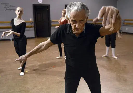 Henry Danton of Petal, Miss., guides students during ballet class at a dance studio in Hattiesburg, Miss., in this March 2013 file photo. Danton danced for many years with the Royal Ballet in London and taught his craft to students in south Mississippi until his death on Feb. 9, 2022. He was 102. (Lici Beveridge/The Clarion-Ledger via AP)