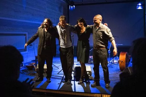 CORRECTS SPELLING OF A NAME  - Wassim Mukdad, Borys Slowikowski, Eden Cami and Or Rozenfeld of Arab-Israeli-Jewish band Kayan Project acknowledge the applause of the audience during a concert at the Jewish theatre boat 'MS Goldberg' in Berlin, Sunday, May 29, 2022. The Berlin band Kayan Project, with a diverse cast of musicians from across the Middle East, might never been able to perform together in the members’ home countries. But it has risen to local fame in Berlin, Germany, with its uniqu