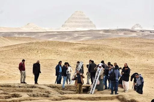 Reporters prepare to enter a recently discovered tomb near the famed Step Pyramid, in Saqqara, south of Cairo, Egypt, Saturday, March 19, 2022. Egypt on Saturday displayed a recently discovered, finely-decorated ancient tombs at an infamous Pharaonic necropolis just outside the capital of Cairo. The five tombs, unearthed earlier this month, date back to the Old Kingdom (1570 B.C. and 1069 B.C.) and the First Intermediate Period, an era spanned for around 125 years after the collapse of the old k