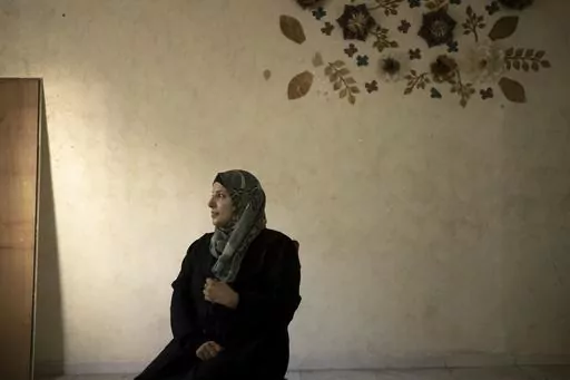 Fida Zalabani, mother of Mohammed Zalabani, a 13 year-old Palestinian in juvenile detention, awaiting trial on murder charges for a Feb. 13 stabbing attack, sits for an interview in the family's emptied apartment which is slated to be demolished by Israeli authorities in the Shuafat refugee camp in east Jerusalem, Wednesday, Aug. 30, 2023. An Israeli court last week dismissed the family's appeal and decided to destroy their home of nearly three years in Shuafat refugee camp, a crowded and garbag