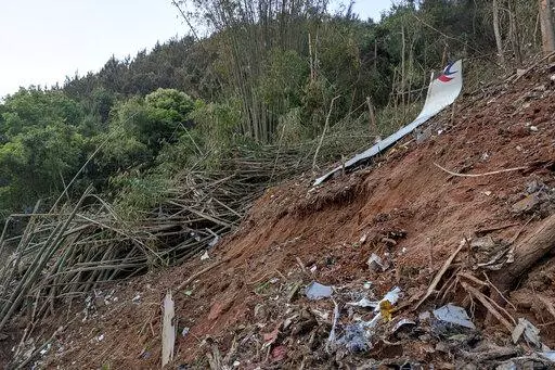 In this photo taken by mobile phone released by Xinhua News Agency, a piece of wreckage of the China Eastern's flight MU5735 are seen after it crashed on the mountain in Tengxian County, south China's Guangxi Zhuang Autonomous Region on Monday, March 21, 2022. A China Eastern Boeing 737-800 with 132 people on board crashed in a remote mountainous area of southern China on Monday, officials said, setting off a forest fire visible from space in the country's worst air disaster in nearly a decade. 