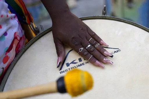 A member of the Turma da Paz de Madureira, or TPM, samba school plays a drum during a rehearsal in preparation for Rio's Carnival parade, in Rio de Janeiro, Brazil, Saturday, Feb. 4, 2023. TPM is the first all-female samba school in Rio. (AP Photo/Silvia Izquierdo)