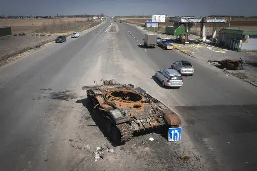 FILE -A Russian tank destroyed in recent fighting is seen on a road to Kyiv, Ukraine, Friday, April 15, 2022.  On Friday, April 22, 2022,  The Associated Press reported on stories circulating online incorrectly claiming a photo of a woman in a military uniform shows a “Ukranian beauty” who “blew up 52 invading Russian tanks.”  (AP Photo/Efrem Lukatsky, File)