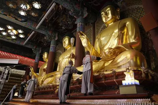 Buddhists monks clean Buddha statues ahead of the upcoming birthday of Buddha on May 15, at the Jogye temple in Seoul, South Korea, Tuesday, May 7, 2024. (AP Photo/Ahn Young-joon)