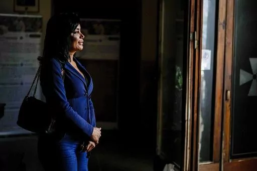 Carla Segovia, a transgender woman from Argentina, walks out of the Beata Vergine Immacolata parish church in Torvaianica, Italy, Thursday, Nov. 16, 2023. Pope Francis’ recent gesture of welcome for transgender Catholics has resonated strongly in this working class, seaside town south of Rome, where a community of trans women has found help and hope through a remarkable friendship with the pontiff forged during the darkest times of the pandemic. (AP Photo/Andrew Medichini)
