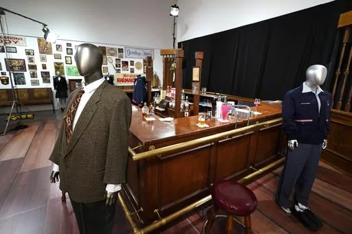 The bar used on the set of the television series "Cheers" and some costumes worn by actors on the sitcom are displayed, April 27, 2023, in Irving, Texas. The bar from the television series “Cheers” sold for $675,000 at auction over the weekend, garnering the highest bid among the nearly 1,000 props, costumes and sets from classic TV shows offered up from a collection amassed by one man over more than three decades. Heritage Auctions said that the items sold during its three-day event that wr