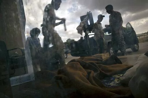 In this Saturday Sept. 7, 2019 photo, fighters of the 'Shelba' unit, allied with the U.N.-supported Libyan government, prepare for combat at the Salah-addin neighborhood front line in Tripoli, Libya. The US is making efforts to convince power brokers in Libya and Sudan to expel the Russian private military company Wagner, regional officials tell The Associated Press. The pressure comes after Washington expanded sanctions on the group. Wagner has played a role in Libya's conflict but has also bee