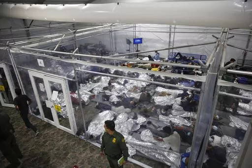 Children lie inside a pod at the main detention center for unaccompanied children in the Rio Grande Valley run by U.S. Customs and Border Protection (CBP), in Donna, Texas, March 30, 2021. A company that provides services for immigrants in federal detention was ordered Tuesday, April 2, 2024, to pay more than $811 million in restitution and penalties in a lawsuit alleging it used deceptive and abusive tactics. (AP Photo/Dario Lopez-Mills, Pool, File)