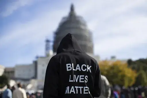 Neal Blair, of Augusta, Ga., wears a hoodie reading "Black Lives Matter" as he stands on the lawn of the Capitol building during a rally to mark the 20th anniversary of the Million Man March, on Capitol Hill, on Oct. 10, 2015, in Washington. (AP Photo/Evan Vucci, File)