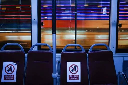 An Olympic shuttle bus passes the National Indoor Stadium, a venue for hockey events, at the 2022 Winter Olympics, Thursday, Feb. 10, 2022, in Beijing. (AP Photo/Jae C. Hong)