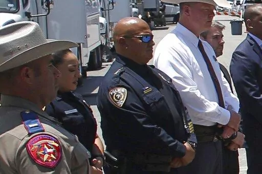 In this May 26, 2022, photo, Uvalde School Police Chief Pete Arredondo, third from left, stands during a news conference outside of the Robb Elementary school in Uvalde, Texas. Facing massive public pressure, Uvalde’s top school official has recommended the firing of the school district police chief who was central to the botched law enforcement response to the shooting at an elementary school that killed two teachers and 19 students.
The city’s school board will consider firing  Arrendondo