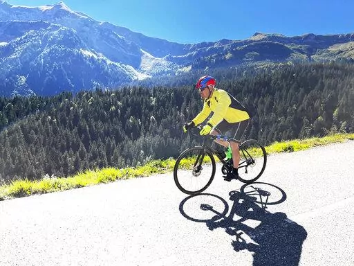 Steve Wartenberg cycles on the D4 road to the summit of the Col de la Colombiere near the village of Le Reposoir in the French Alps on Sept. 20, 2022. (Mike Booth via AP)