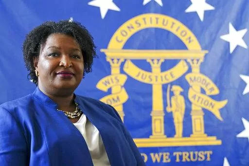 Democratic candidate for Georgia governor Stacey Abrams poses for a portrait in front of the State Seal of Georgia on Aug. 8, 2022, in Decatur, Ga. Abrams founded Fair Fight Action, a group focused on fair elections, that filed a wide-ranging federal lawsuit alleging “gross mismanagement” of Georgia’s elections. That lawsuit sputtered out Friday, Sept. 30, with Fair Fight losing its last remaining arguments, more than a year after the judge had tossed most earlier claims. (AP Photo/John Ba