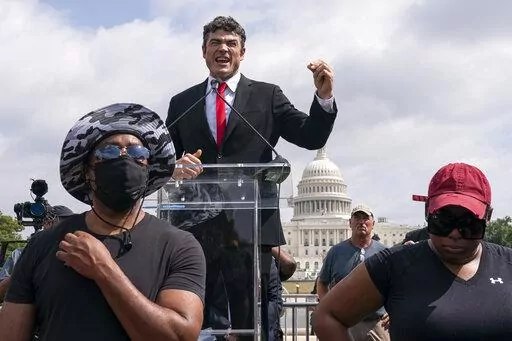 Joe Kent, center, a Republican who is challenging Rep. Jaime Herrera Beutler, R-Wash., for her seat in Washington's 3rd Congressional District, speaks during a "Justice For J6" rally near the U.S. Capitol in Washington, on Sept. 18, 2021, in support of people who took part in the Jan. 6 insurrection at the U.S. Capitol. Kent has openly displayed ties to far-right and extremist organizations in his election run. That includes groups that have drawn law enforcement scrutiny over their involvement 