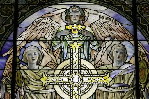 A detail of "The Righteous Shall Receive a Crown of Glory," Brainard Memorial Window for Methodist Church, Waterville, New York, ca. 1901 is photographed while on display at the "Louis C. Tiffany and the Art of Devotion" exhibit at the Museum of Biblical Art in New York on Thursday, Oct. 25 2012. About 7 in 10 U.S. adults say they believe in angels, according to a new poll released on Saturday, July 29, 2023, by The Associated Press-NORC Center for Public Affairs Research. (AP Photo/Mary Altaffe