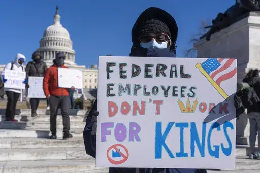 A federal employee, who asked not to use their name for fears over losing their job, protests with a sign saying "Federal Employees Don't Work for Kings" during the "No Kings Day" protest on Presidents Day , Feb. 17, 2025, near the Capitol in Washington. (AP Photo/Jacquelyn Martin, File)