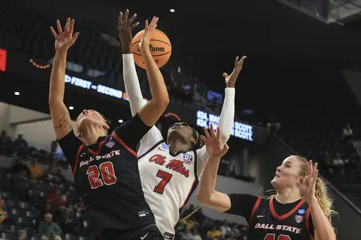 Ole Miss forward Starr Jacobs grabs the loose ball between Ball State forward Alex Richard, left, and forward Elise Stuck, right, during the second half in the first round of the NCAA college basketball tournament, Friday March 21, 2025, in Waco, Texas. (AP Photo/Jerry Larson)