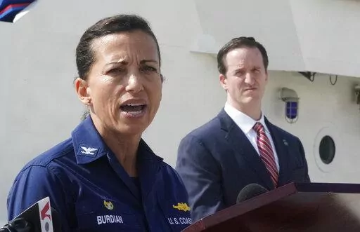 U.S. Coast Guard Captain Jo-Ann Burdian, foreground, speaks along with Homeland Security Investigations Special Agent in Charge in Miami Anthony Salisbury, rear, during a news conference, Thursday, Jan. 27, 2022, at Coast Guard Sector Miami in Miami Beach, Fla. The Coast Guard says it has found four more bodies in its search for dozens of migrants lost at sea off Florida, for a total of five bodies. The maritime security agency said Thursday that it also plans to call off its active search for s