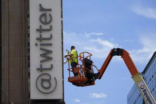 A workman removes a character from a sign on the Twitter headquarters building in San Francisco, Monday, July 24, 2023. Elon Musk may want to send “tweet” back to the birds, but the ubiquitous term for posting on the site he now calls X is here to stay, at least for now. For one, the word is still plastered all over the website formerly known as Twitter. Write a post, you still need to press a blue button that says “tweet” to publish it. To repost it, you still tap “retweet.” (AP Pho