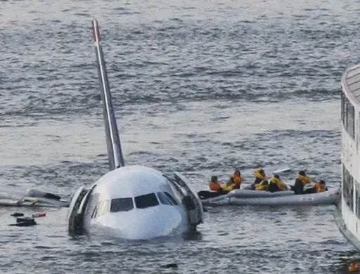 In this Jan. 15, 2009 file photo, passengers in an inflatable raft move away from US Airways Flight 1549 that went down in the Hudson River in New York. (AP Photo/Bebeto Matthews, File)