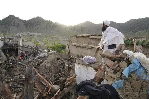 A man stands among destruction after an earthquake in Gayan village, in Paktika province, Afghanistan, Thursday, June 23, 2022. A powerful earthquake struck a rugged, mountainous region of eastern Afghanistan early Wednesday, flattening stone and mud-brick homes in the country's deadliest quake in two decades, the state-run news agency reported. (AP Photo/Ebrahim Nooroozi)