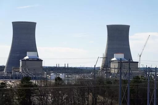 Units 3, left, and 4 and their cooling towers stand at Georgia Power Co.'s Plant Vogtle nuclear power plant, Jan. 20, 2023, in Waynesboro, Ga. Georgia's Public Service Commission voted 5-0 on Tuesday, Dec. 19, 2023 to approve a 6% rate increase for remaining costs that will take effect once Unit 4 begins commercial operation. (AP Photo/John Bazemore, File)