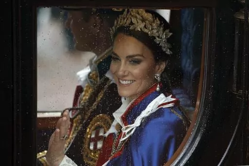 Kate, Princess of Wales and Prince William travel in a coach following the coronation ceremony of Britain's King Charles III in London, Saturday, May 6, 2023. (AP Photo/David Cliff, File)