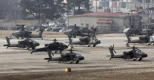 U.S. Army Apache helicopters take off at Camp Humphreys in Pyeongtaek, South Korea, Monday, March 4, 2024. North Korea called the ongoing South Korean-U.S. military drills a plot to invade the country, as it threatened Tuesday to take unspecified "responsible" military steps in response. (Kwon June-woo/Yonhap via AP)